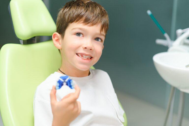 Boy wear dental orthodontic plate for teeth. Orthodontics